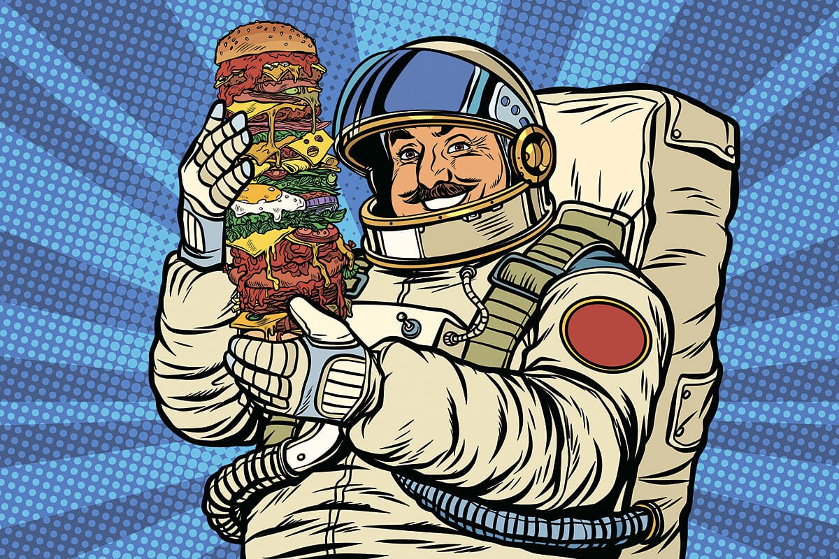 Picture of a hungry astronaut with a huge burger in his hands