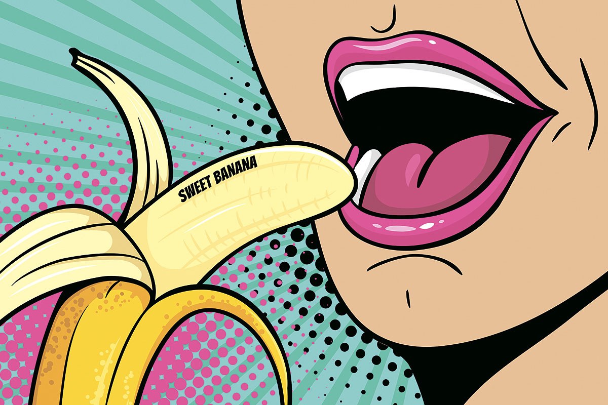 Young girl eating delicious banana