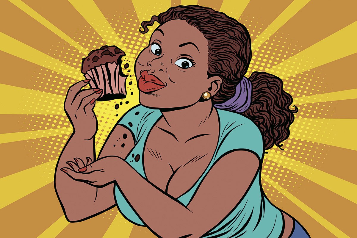 Picture of a hungry woman with a cupcake in her hands