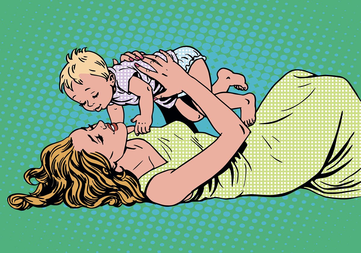Happy mom lies with her baby