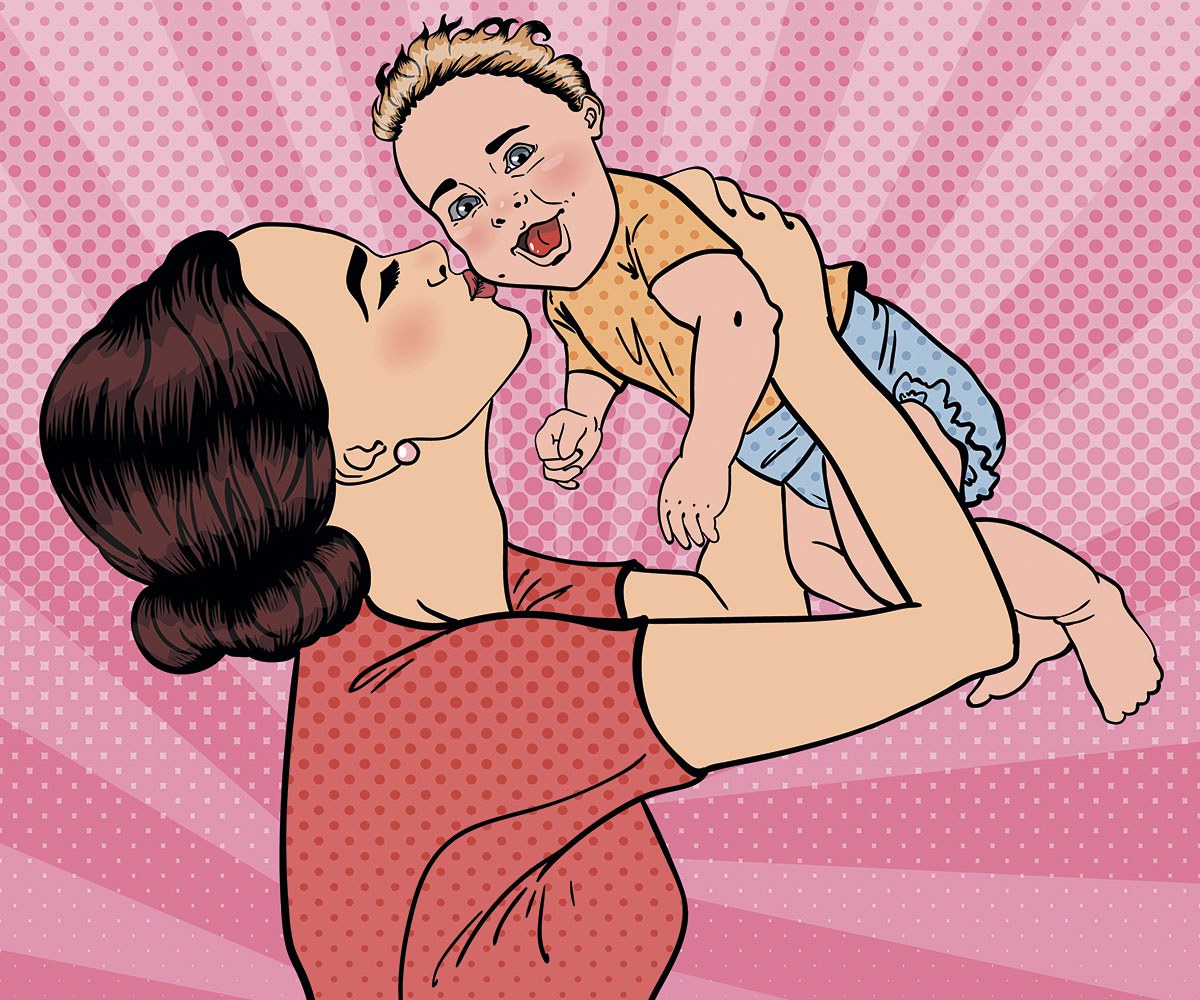 Joyful mom kisses her cute baby
