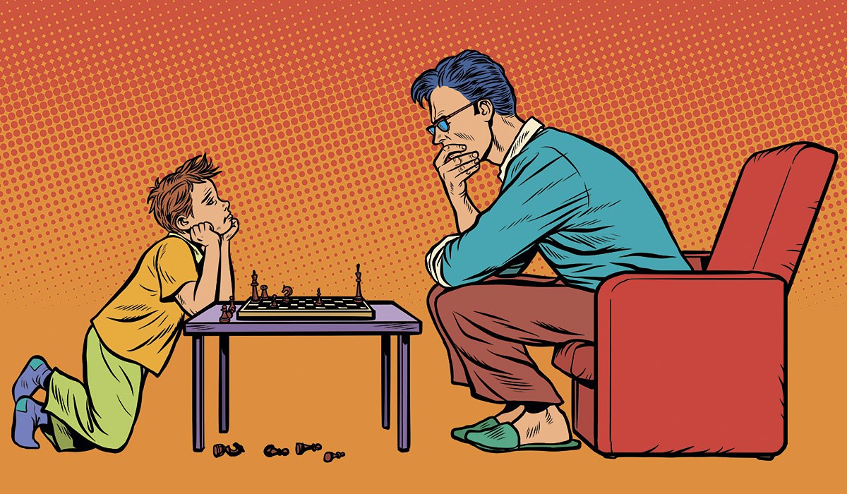 Picture of a father and his son playing chess
