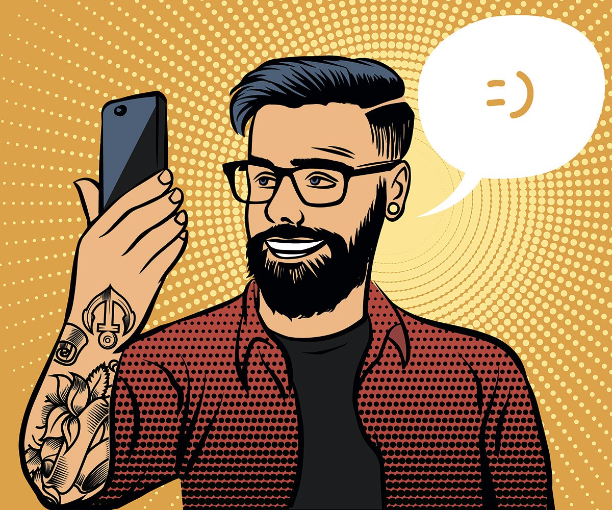 Charming young man looking at a mobile phone