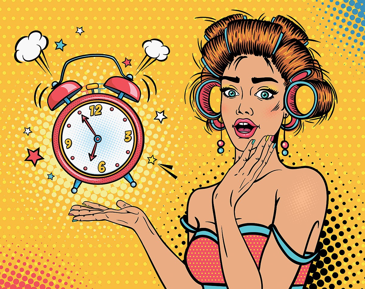 Surprised woman looks at the ringing alarm clock in the morning